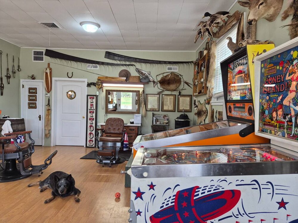 Inside Coyote's Den Barbershop — vintage leather barber chairs and eclectic decor