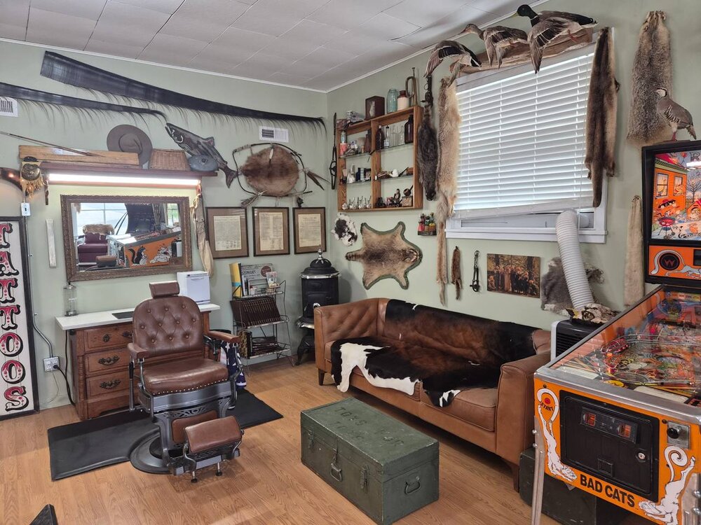 Rustic barbershop interior with leather chair, sofa and decor